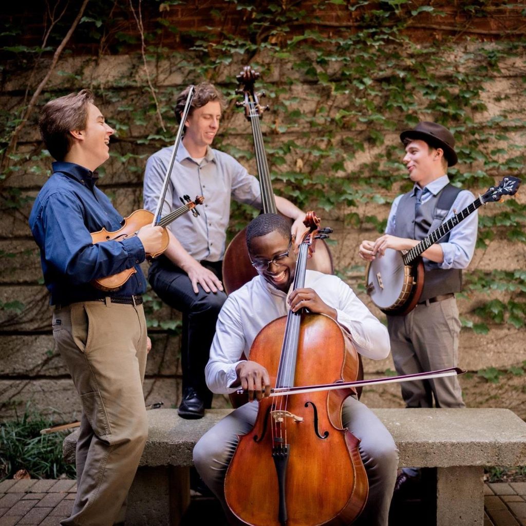 Grant with The Westbound situation. From left to right, Grant, Jacob Warren (bass), Zach Brown (cello), Matthew Davis (banjo). Photo by Beth Flick.